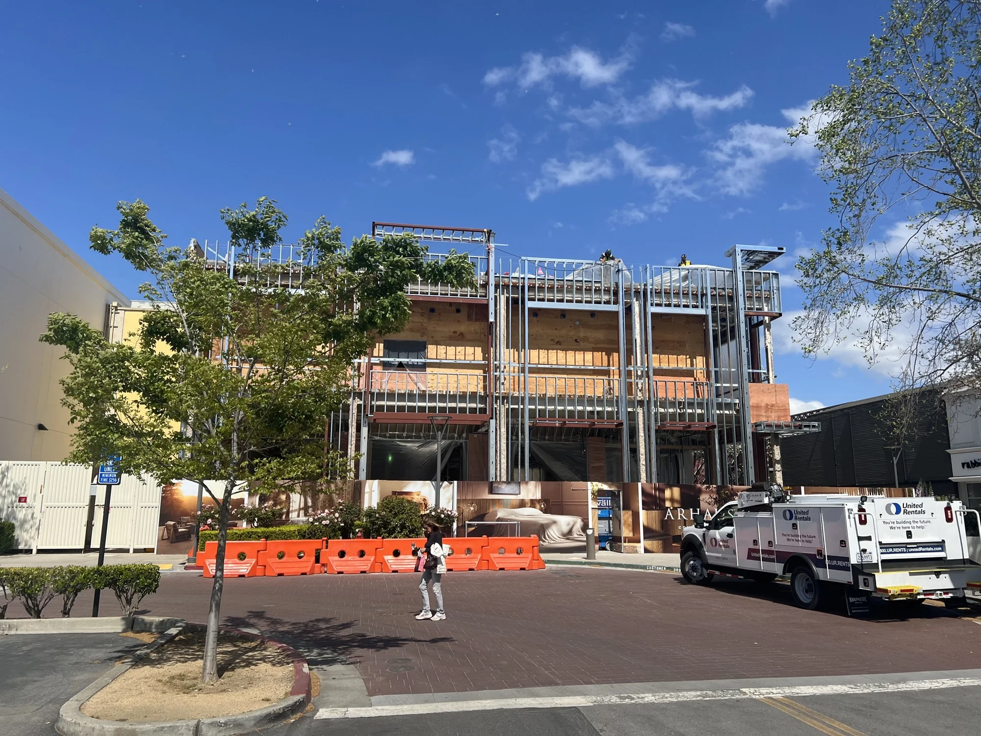 Exterior metal framing above a pedestrian street